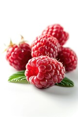 Raspberries arranged in a group on a clean white surface. Ideal for food-related projects and healthy eating concepts