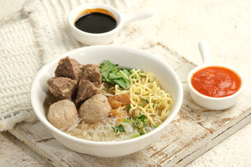 bakso or baso . indonesian meatball soup served with noodle and sambal