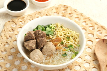 bakso or baso . indonesian meatball soup served with noodle and sambal