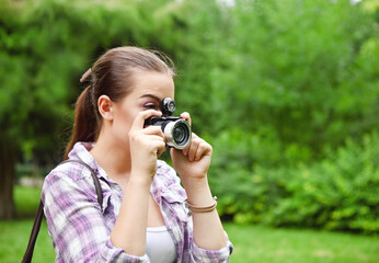 Beautiful smiling young girl with camera
