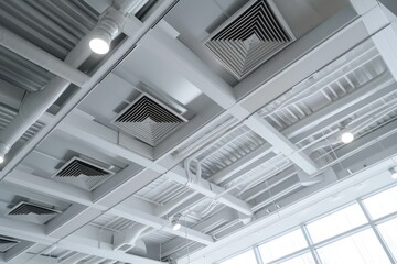 A picture of a ceiling with a cluster of air vents. This image can be used to illustrate ventilation systems or architectural design