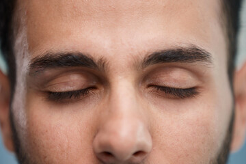 Fototapeta premium young beautiful man with brown eyes looks at the camera.