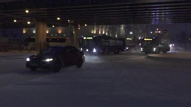 Heavy snowfall overnight (weather disturbance), has been hammered with snow. City transport drives on a snow-covered road. Super slow motion 1000 fps.