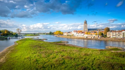 Fotobehang Scenic view of the town of Deventer along a river in the Netherlands © Wirestock