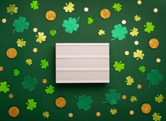 Golden Horseshoe, Gold Coins and Clover Leaves Shamrocks on Green Background for St Patricks Day...