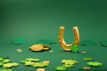 Golden Horseshoe, Gold Coins and Clover Leaves Shamrocks on Green Background for St Patricks Day...