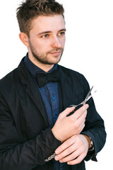 A man cloaked in darkness holds a pair of shining scissors, poised to cut through the unseen.