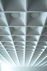 A picture of a ceiling with numerous holes. Can be used to depict a deteriorating infrastructure or the need for repairs