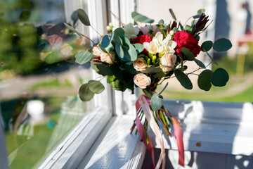 A vibrant collection of flowers in full bloom adds a touch of natural beauty to a sun-kissed window sill.