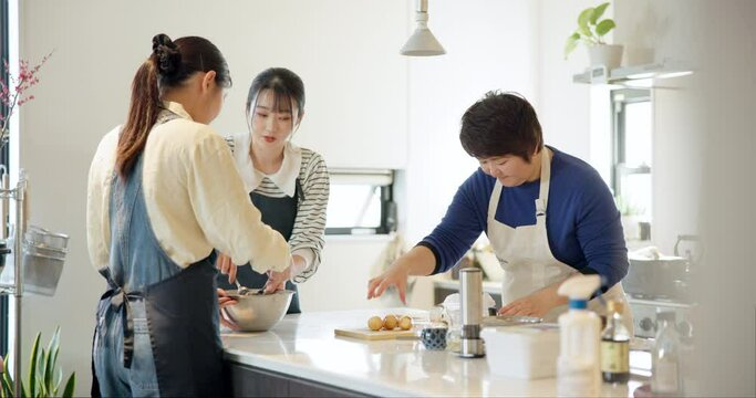 Cooking lesson, students and learning to cook, chef and japanese food in kitchen, professional and skill. Restaurant, teaching and course for culinary job, working together and aprons for cleanliness