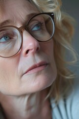 Close up shot of a woman wearing glasses. Suitable for business, education, or lifestyle concepts