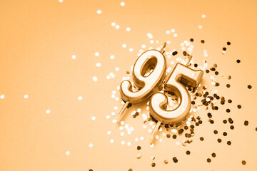 95 years celebration festive background made with golden candles in the form of number Ninety-fifth...
