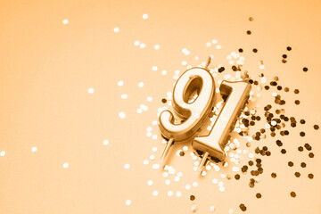 91 years celebration festive background made with golden candles in the form of number Ninety-one lying on sparkles. Universal holiday banner with copy space. - obrazy, fototapety, plakaty