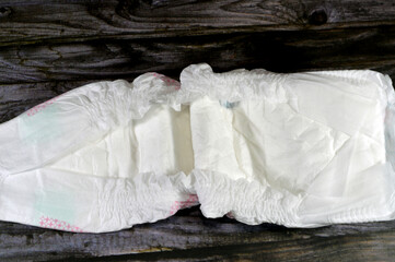 A diaper or a nappy, a type of underwear that allows the wearer to urinate or defecate without...