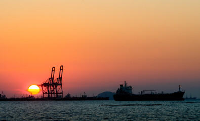 Silhouette of a cargo port image , Cargo ports are facilities that are used to load and unload cargo from ships