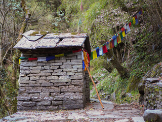 Small buddhist house sanctuary with tibetan flags