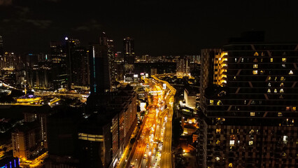 Obraz premium Aerial view of the night city of Kuala Lumpur in Malaysia. Capital city in Southeast Asia. View of the streets in the light of night lights, traffic on the roads at night.
