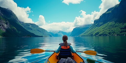 Woman kayaking on fjord in Norway. Beautiful landscape. - obrazy, fototapety, plakaty