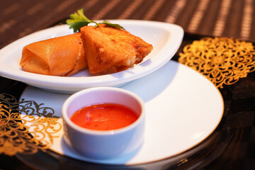 Chinese spring rolls and deep-fried bread with shrimp paste made by a chef of an authentic Chinese restaurant