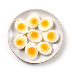 Plate with cut boiled eggs on white background