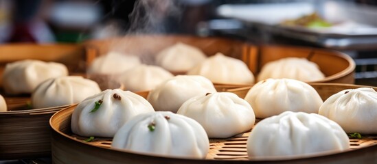 Selective focus on traditional Vietnamese banh bao steamed bun with pork filling at street food market.