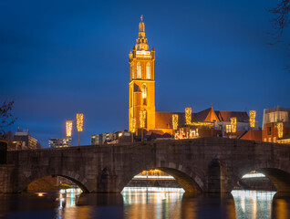 Fototapeta premium Dutch city of Roermond in the evening, view of the stone bridge and the St. Christopher's Cathedral