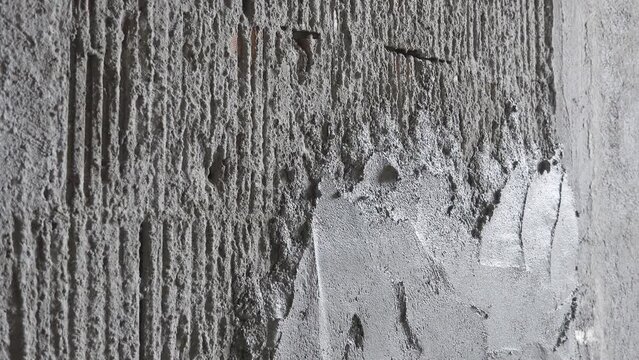 Worker hand with tool applying the plaster mortar on cement wall