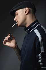 Portrait of a young sad guy in black clothes on a black background. Depressive portrait.