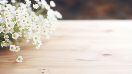 A bouquet of white baby's breath flowers lays on a rustic wooden surface, giving a natural and delicate touch. - obrazy, fototapety, plakaty