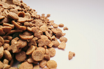 Dry cat food on a grey background.