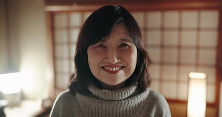 Face, smile and a Japanese woman at home, house and alone in apartment at night. Happy portrait of confident mature female person, cheerful and healthy facial expression of casual lady in living room