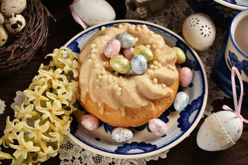 Top view of homemade Easter ring cake with white chocolate glaze on wooden table