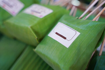 Grilled pork on skewers wrapped in banana leaves, healthy food