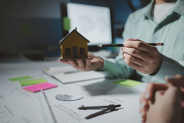 Architects are reviewing plans together, Construction and structure of engineer or architect meeting for project working with partner and tools on model building and blueprint in working site