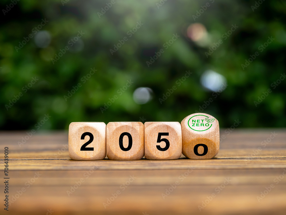 Aufkleber 2050 year number on flipping block with green net zero icon on green leaves background. net zero by 