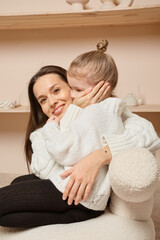 Fototapeta premium Happy young mother embracing her lovely little daughter