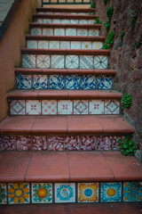 Beautiful stairs with nice colorful tile mosaic ornament puzzle in traditional Italian sicilian style. High quality photo