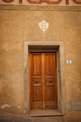 Old wooden italian door in an old building. Historical city elements Classic european architecture in Florence, Italy