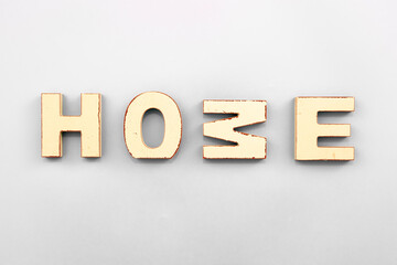 The word Home from wooden letters on a white background.