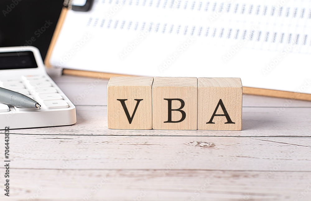 Poster vba word on a wooden block with clipboard and calculator