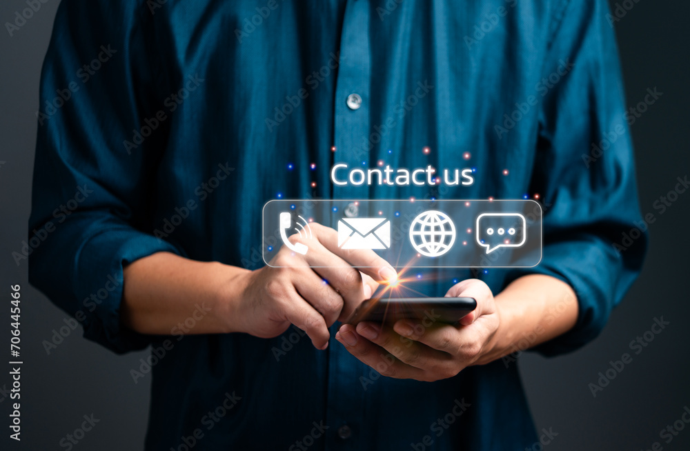 Poster Male hand holding a mobile phone with contact us communication icon. Digital concepts, customer service and marketing, advertising business