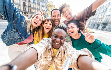 Multiracial best friends taking selfie walking on city street - Happy young people having fun...