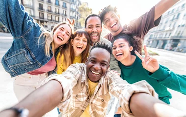 Fotobehang Multiracial best friends taking selfie walking on city street - Happy young people having fun enjoying day out - Diverse teens laughing at camera on summer vacation - Friendship and tourism concept © Davide Angelini
