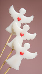 Angels lollipops on a pink background.