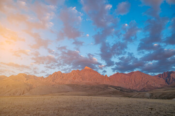 Red mountains the extension of the Taurus Mountains the harmony of the sunset coloured clouds and the steep rocks of its surroundings with the sky and sun light