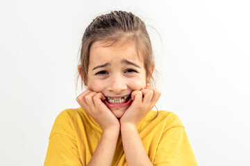 Scared and anxious girl, biting her fingernails on a white background isolated.