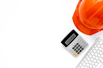 Construction helmet with calculator on builders or designers desk. Architectural project concept