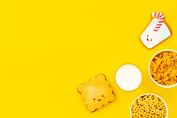 Kids breakfast with milk and funny cookies with cornflakes