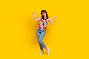 Fototapeta na wymiar Full body photo of overjoyed girl wear striped tank denim trousers hands up celebrate black friday isolated on yellow color background