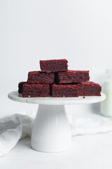 red velvet brownies on a white marble cake stand, red velvet fudge brownies on a white background